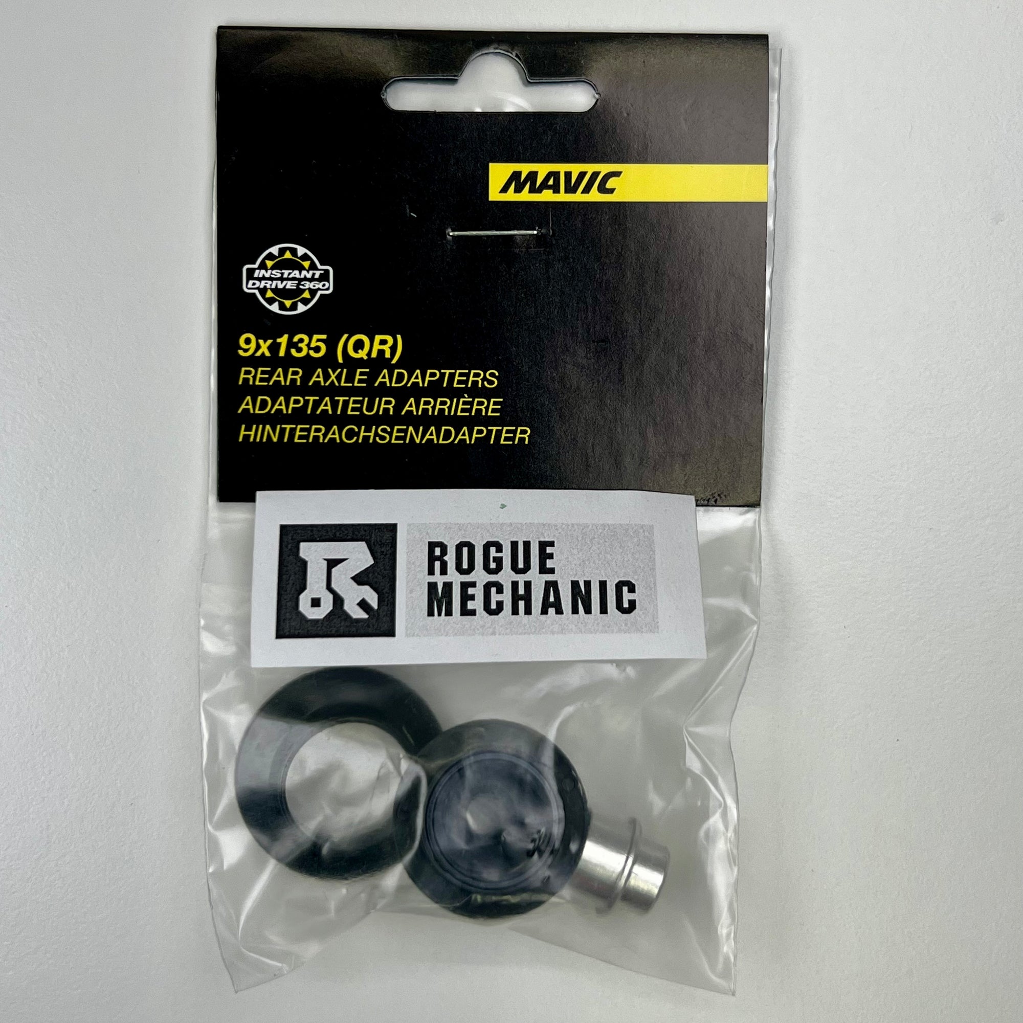 Mavic QRM Auto Rear Axle Adapters 9x135 packaged in a clear plastic bag with a black and yellow label, and a Rogue Mechanic sticker. V2510801